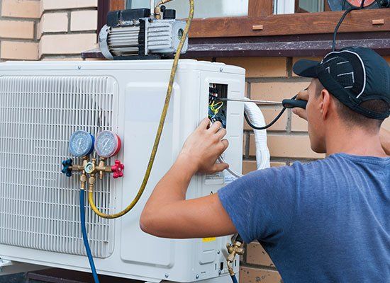 Worker Installing Air Condition — Hatfield, MA — AM/PM Plumbing & Heating