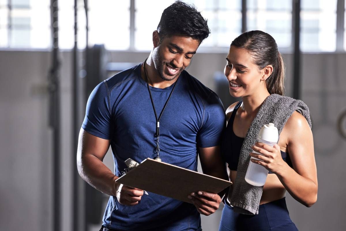 A personal trainer discussing workout plans and progress a boutique gym near Lexington, Kentucky (KY)