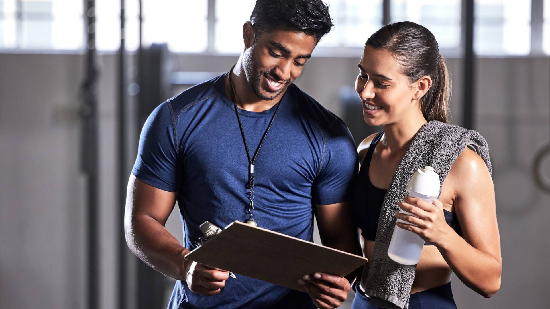 A personal trainer discussing workout plans and progress a boutique gym near Lexington, Kentucky (KY