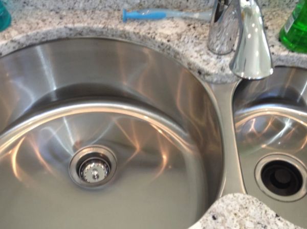 Double stainless steel kitchen sink with granite countertop and faucet