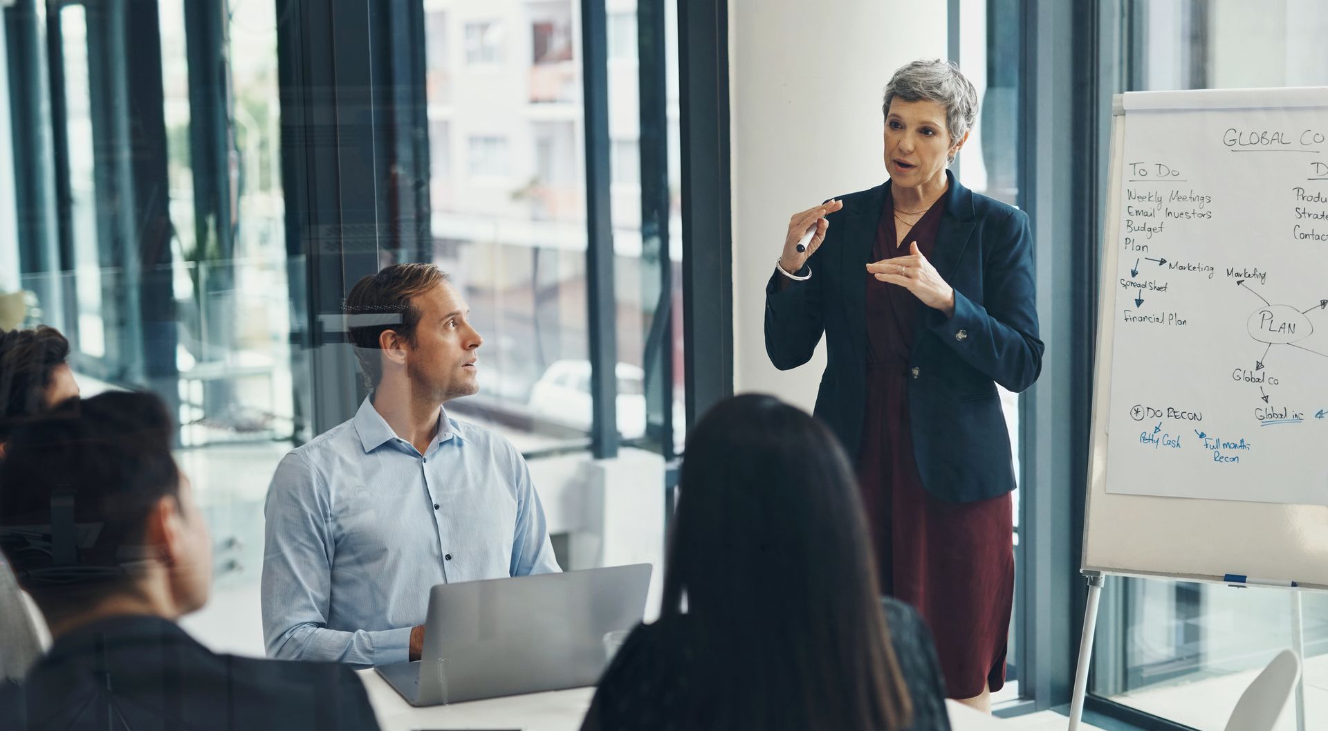 A woman is giving a presentation to a group of people.