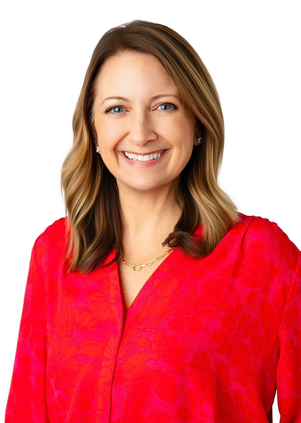 A woman in a red shirt is smiling for the camera.