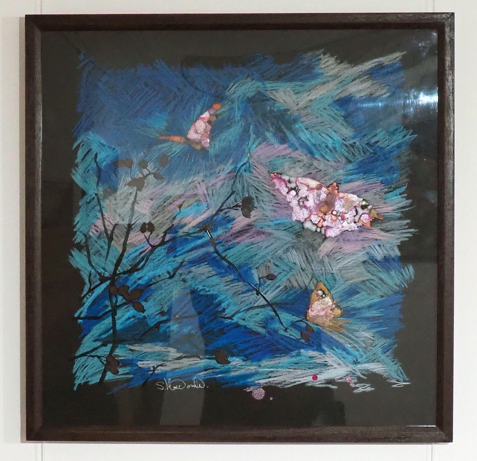 Energetic blues, grey and pink scratch-like marks on black resemble the sky on which three butterflies hover over a silhouette of Rose Hip branches. The butterflies are orange, pinks and silver metallics. Simple dark brown wood frame behind perspex.   