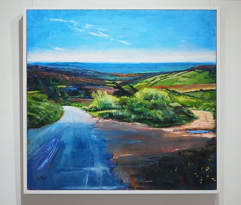 A square painting looking towards the sea over hills of fields and trees. In the foreground there is a choice of a tarmac road to the left and a dirt road to the right. The bottom in dark and in shade the choice of road is light. the horizon is white merging to a bright blue sky.