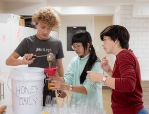 Adolescent students working together on a Montessori project, building confidence and purpose.
