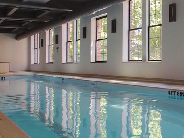 A large indoor swimming pool that is 4 feet deep