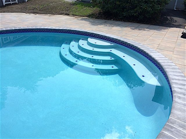 A swimming pool with stairs leading up to it