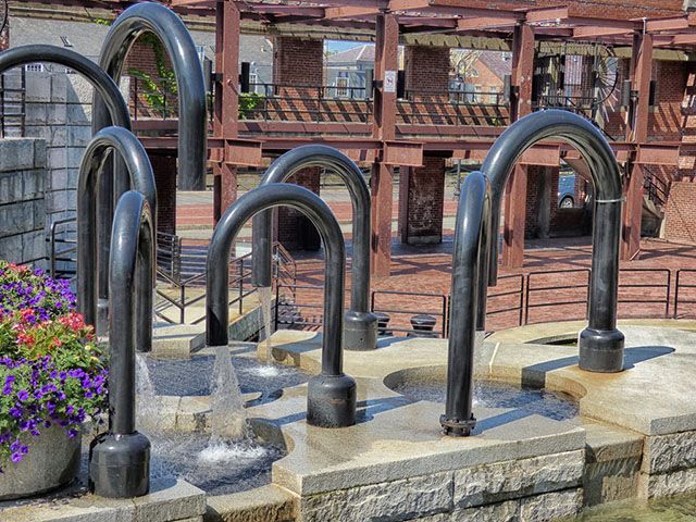 A fountain with a bunch of pipes coming out of it