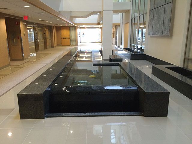 A large hallway with a fountain in the middle