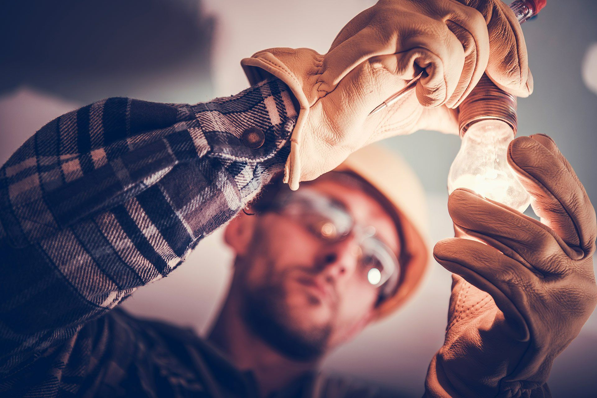 A certified electrician from ONit Building Services expertly handles electrical components, demonstr