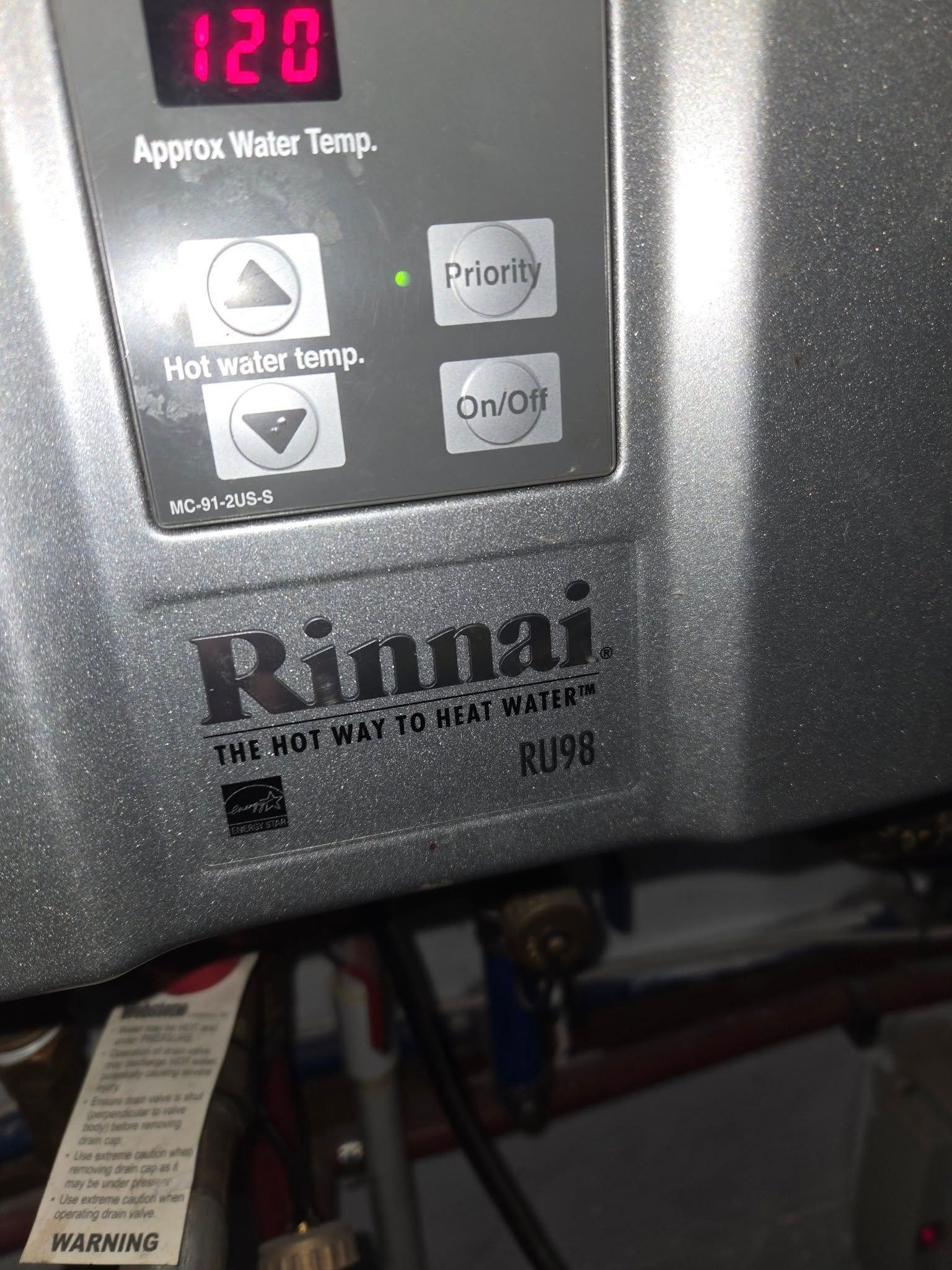 Close-up of a Rinnai KU98 tankless water heater control panel displaying 120 degrees.