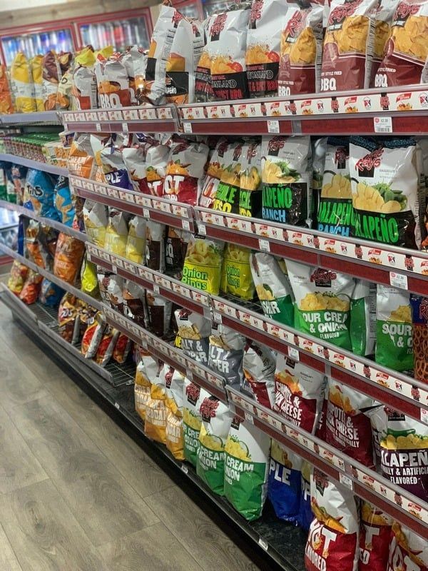 A grocery store aisle filled with bags of chips.