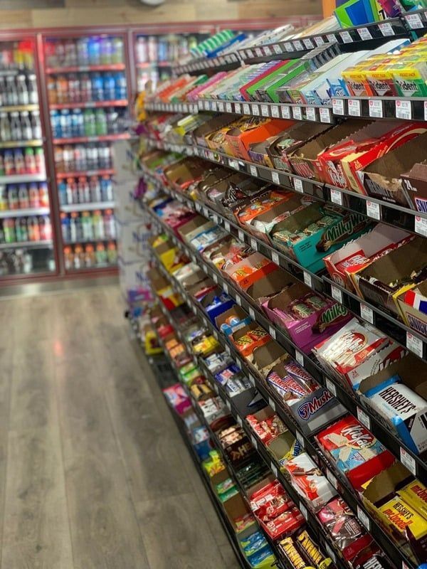 A grocery store aisle filled with lots of candy.