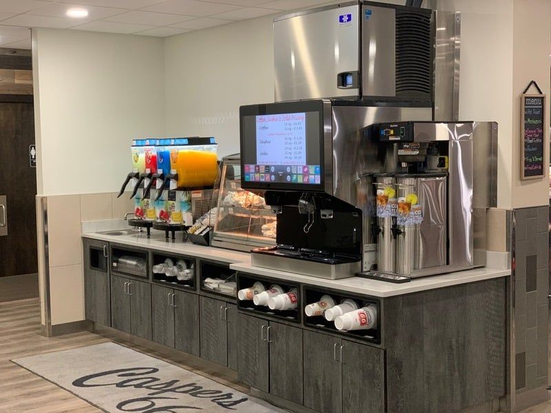 A restaurant with a lot of appliances and a tv on the counter.