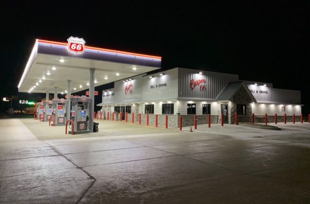 A gas station is lit up at night.