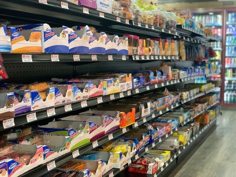 A grocery store aisle filled with lots of food and drinks.
