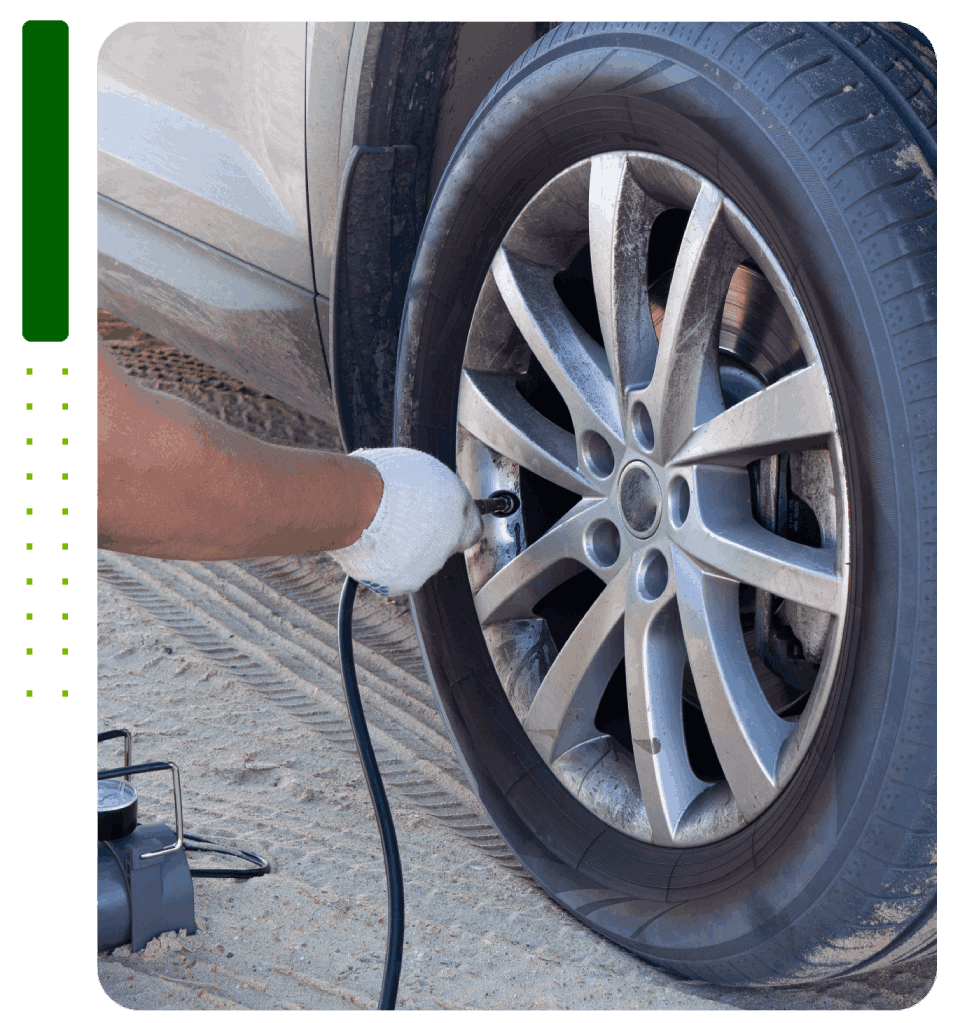 A person is inflating a tire with an air pump.