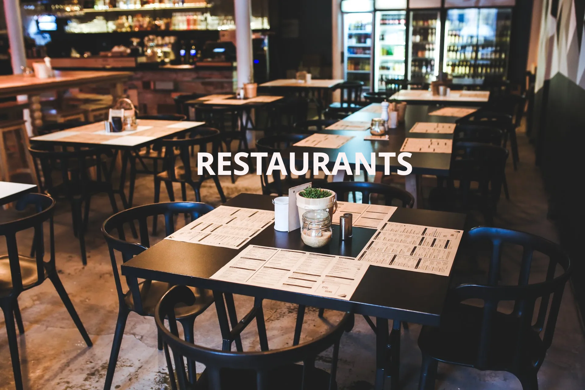 A restaurant with tables and chairs and the word restaurants on the bottom.