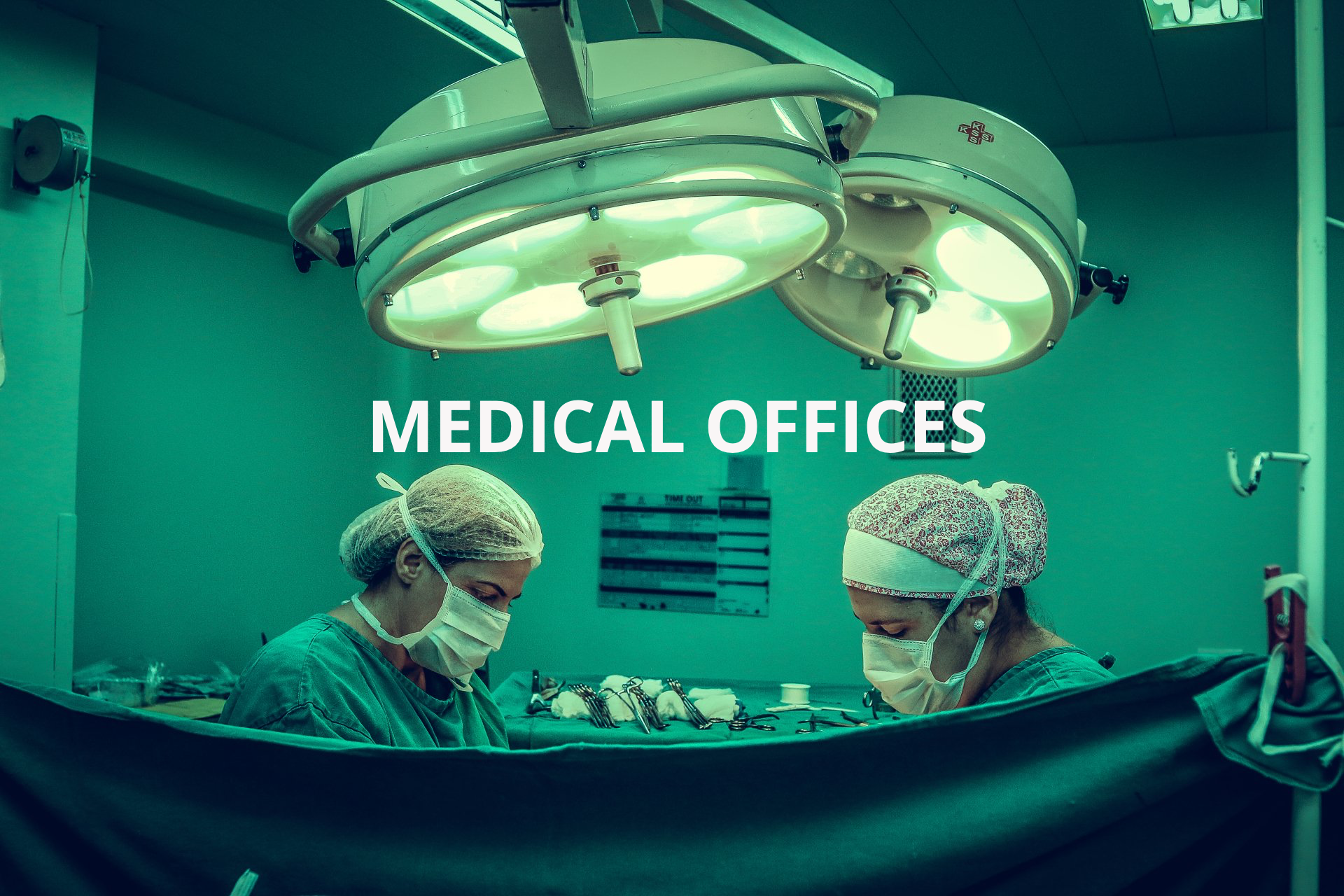 Two surgeons are operating on a patient in an operating room.