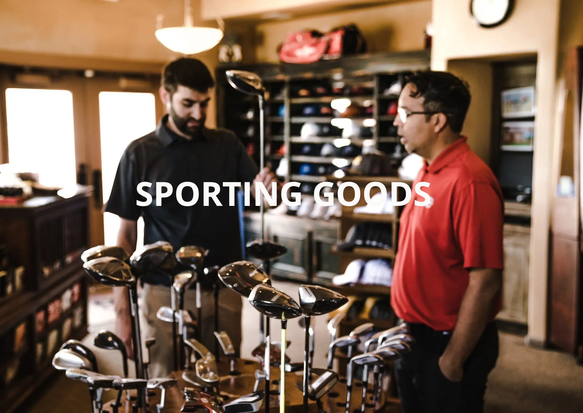 Two men are looking at golf clubs in a sporting goods store.