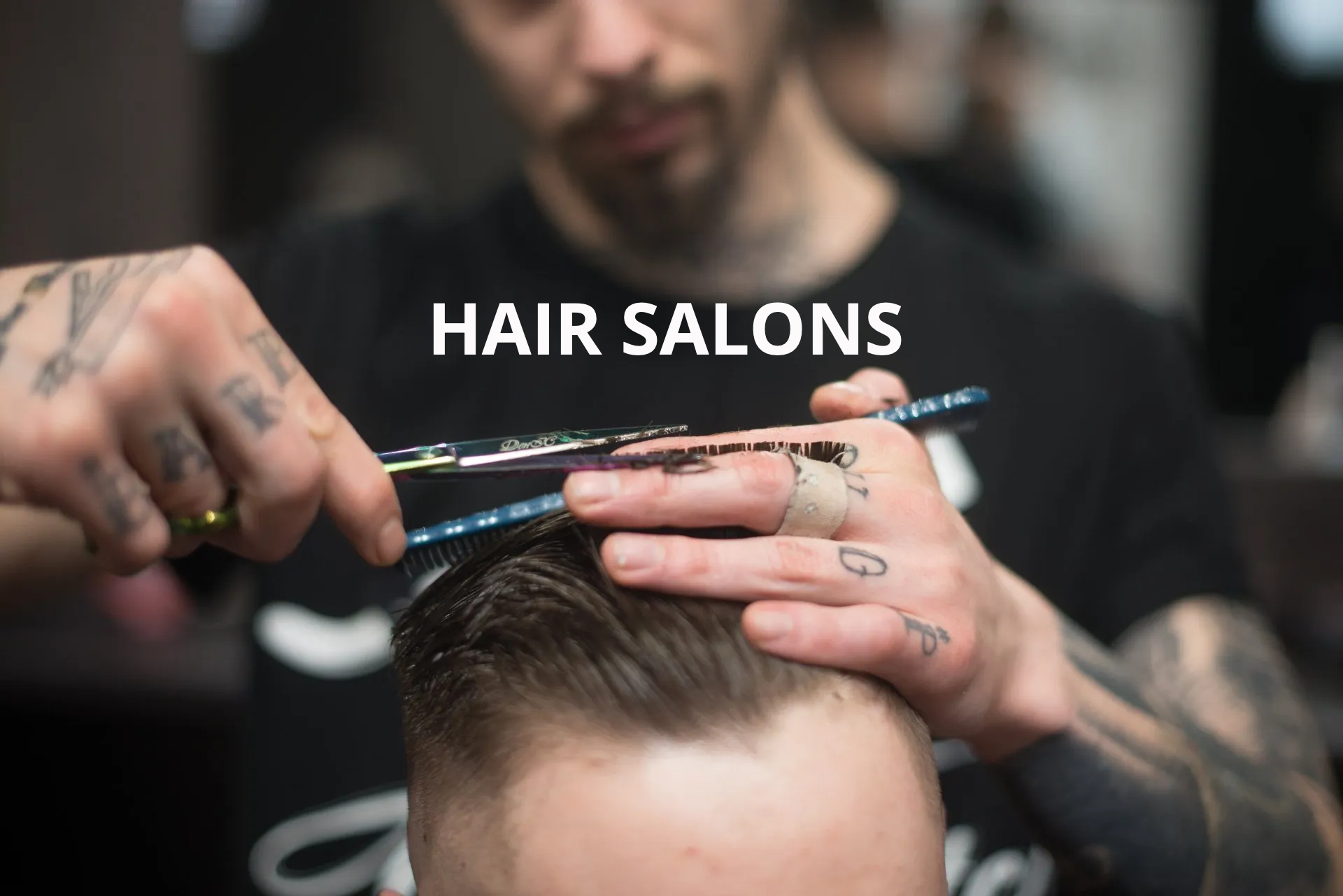 A man is getting his hair cut at a hair salon.