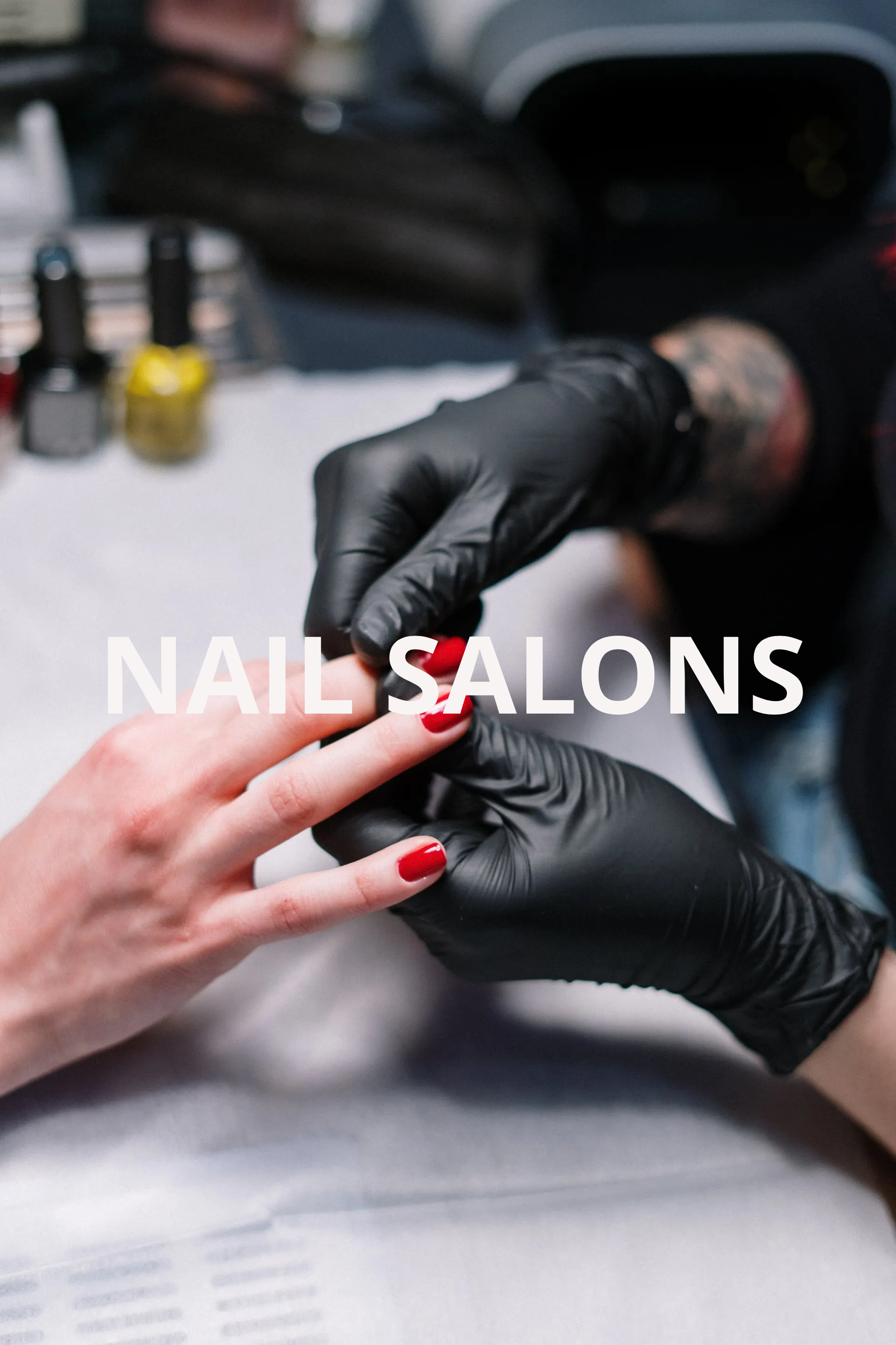 A woman is getting her nails painted in a nail salon