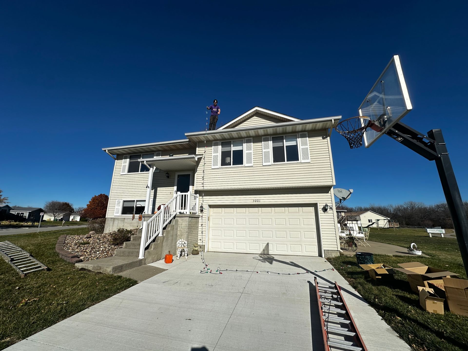A white house with a basketball hoop in front of it