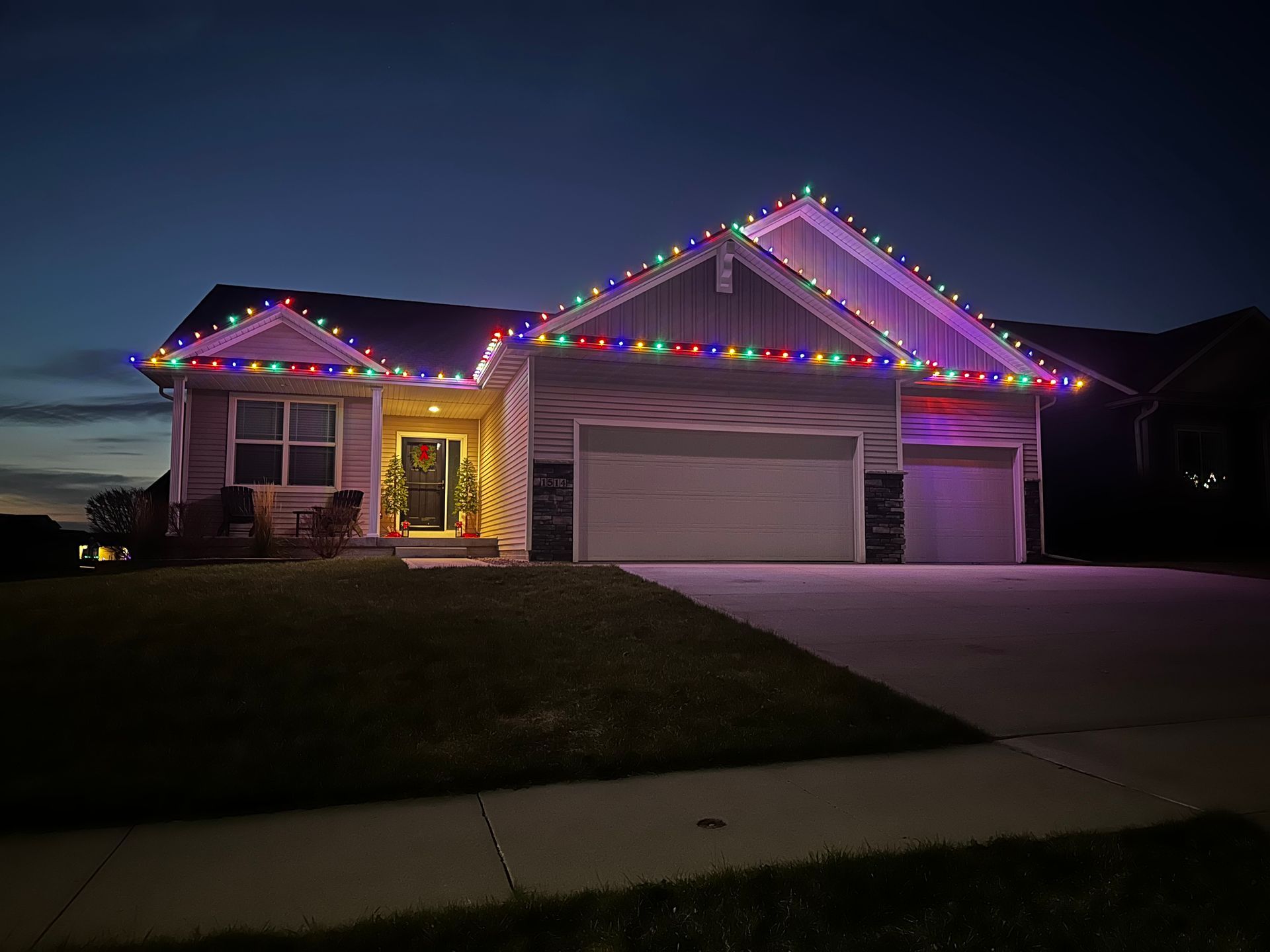 A house is decorated with christmas lights at night.