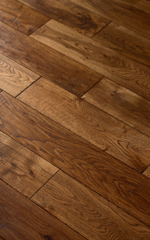 A close up of a wooden floor in a room.