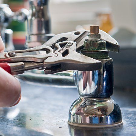 Clute Plumbers — Person Fixing Faucet in Clute, TX