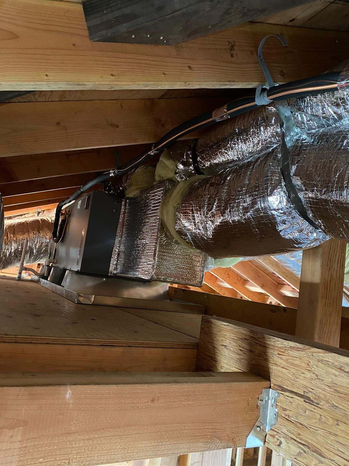 A duct is hanging from the ceiling of a building.