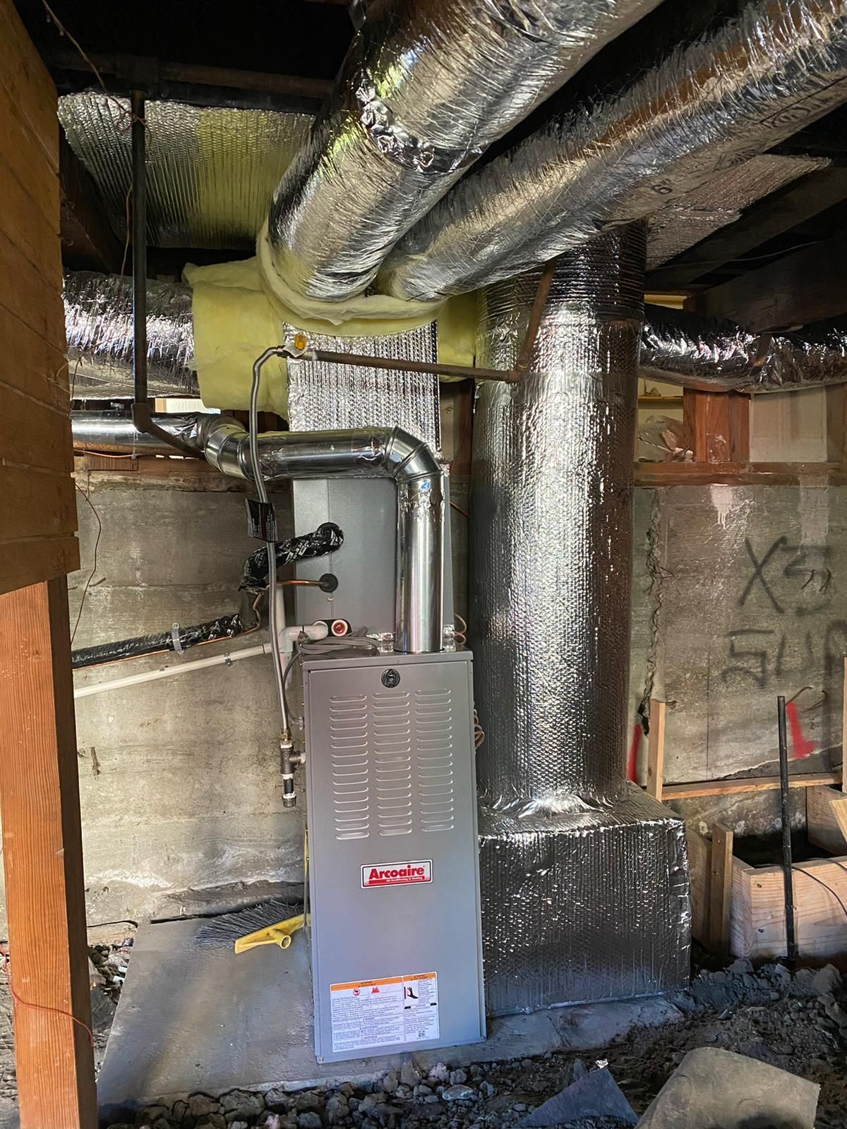 A heating and cooling system is being installed in a basement.