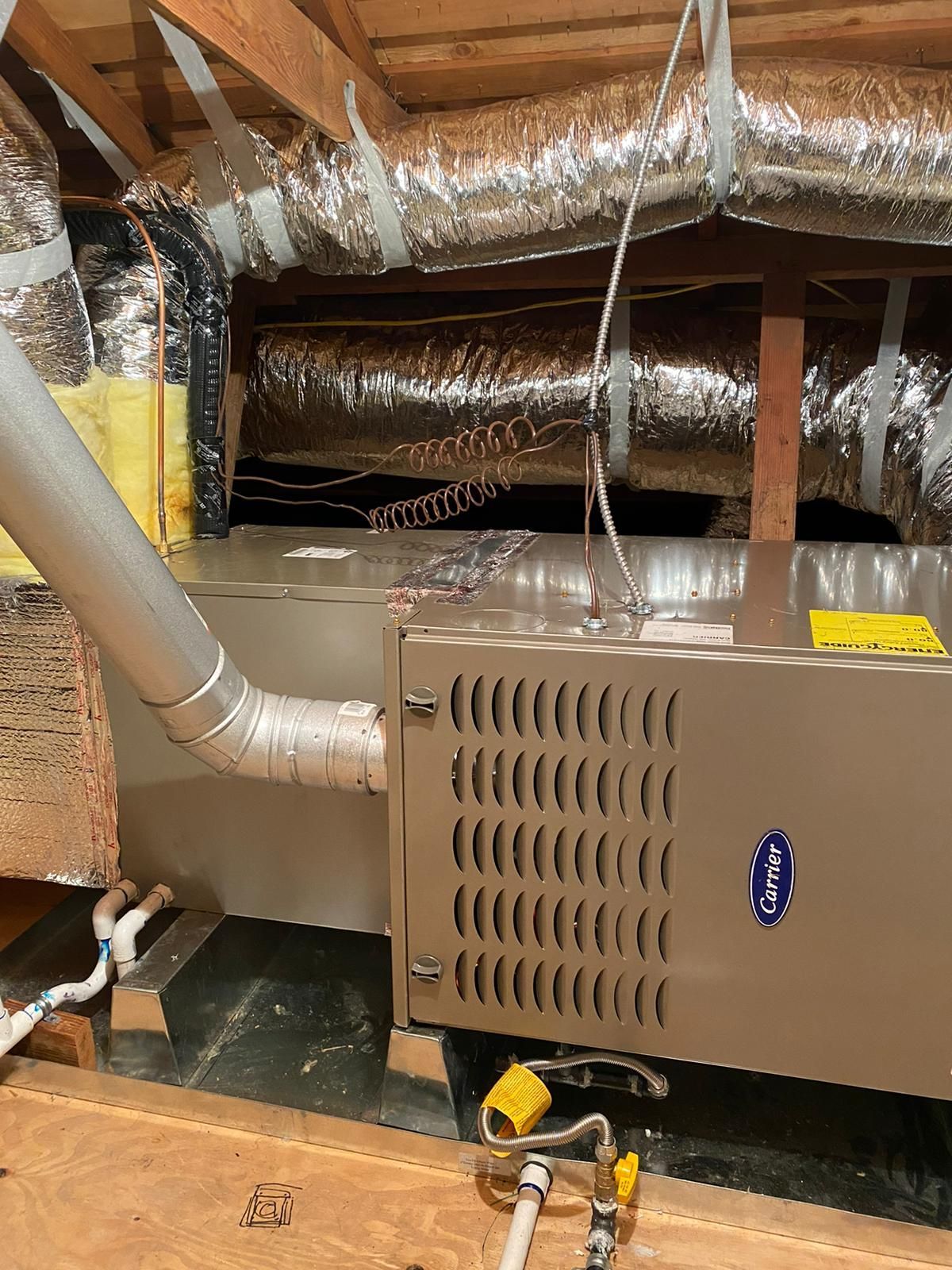 A ventilation system is installed in the attic of a house.