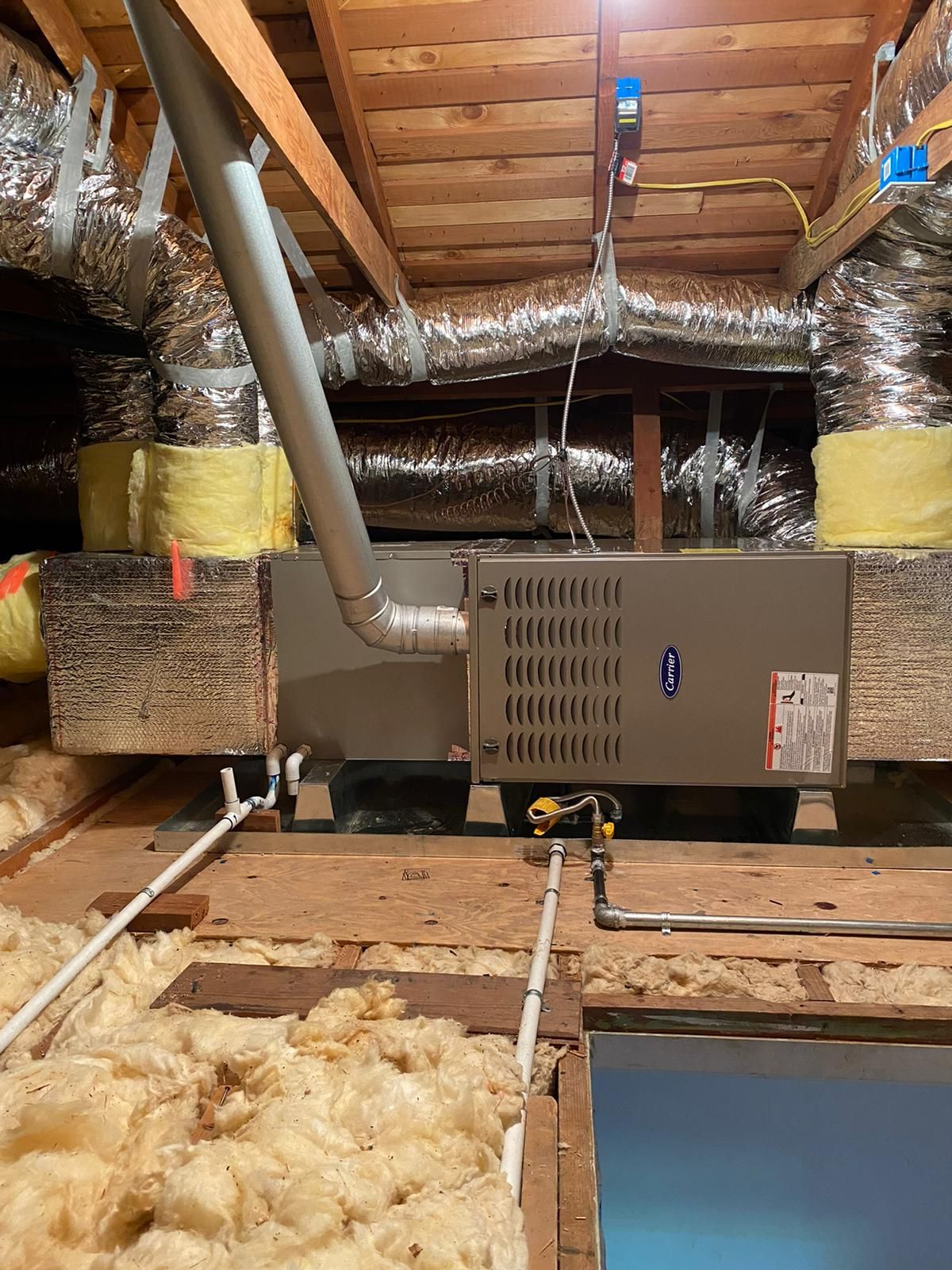 There is a furnace in the attic of a house.