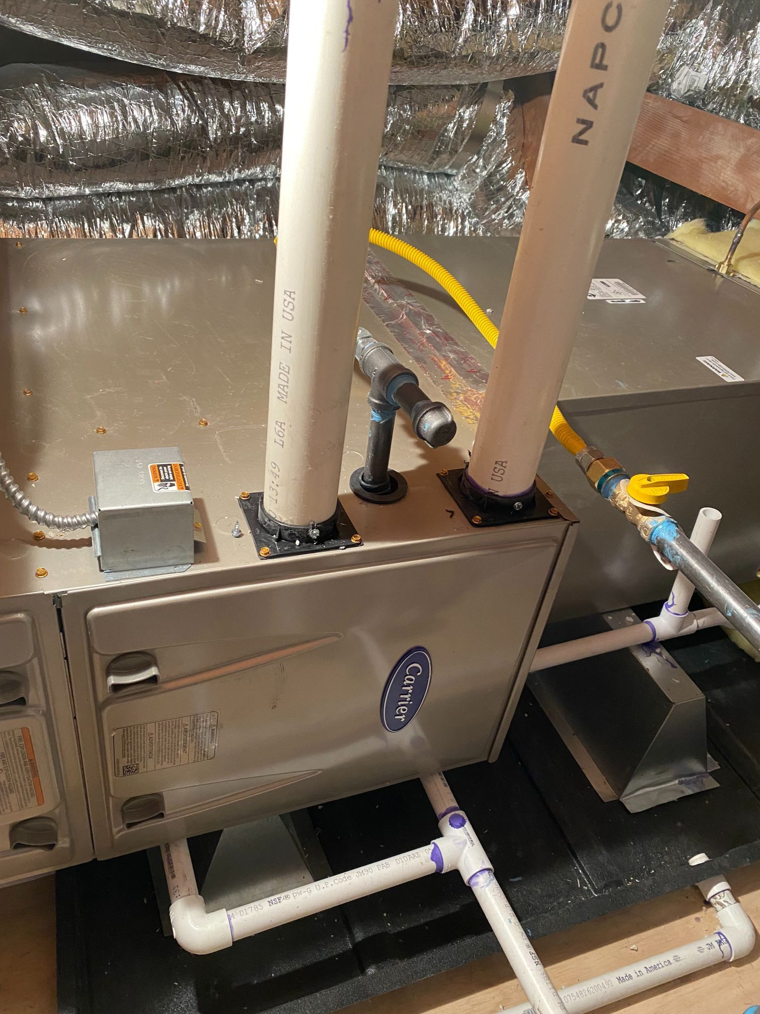 A close up of a heating system with pipes coming out of it.