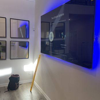 A room with a large flat screen tv hanging on the wall.