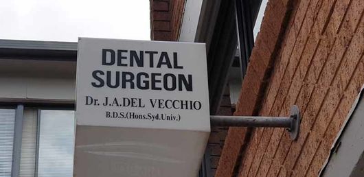 dental surgeon business sign on brick building