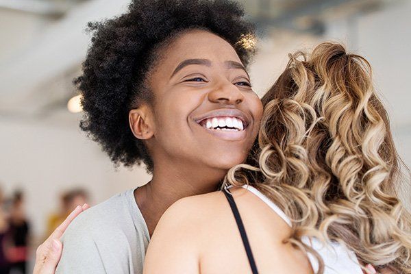 two women hugging each other