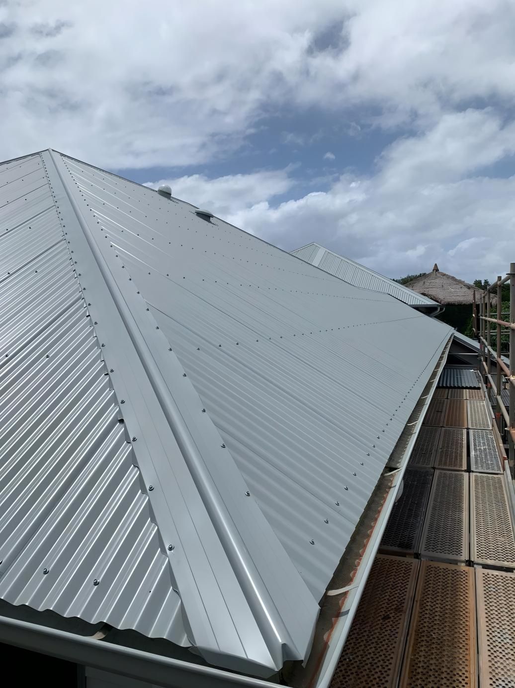 The underneath of a roof showing a large green gutter pipe — Blue Sky Roofing NSW In Mullumbimby, NSW