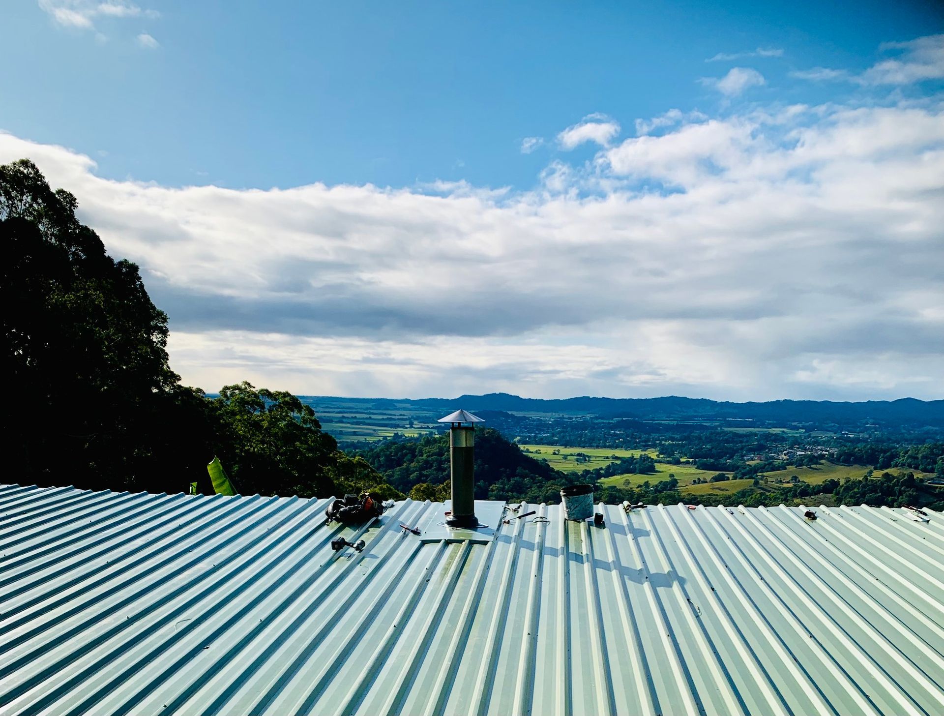 A green metal roof looking out to land — Blue Sky Roofing NSW In Ocean Shores, NSW