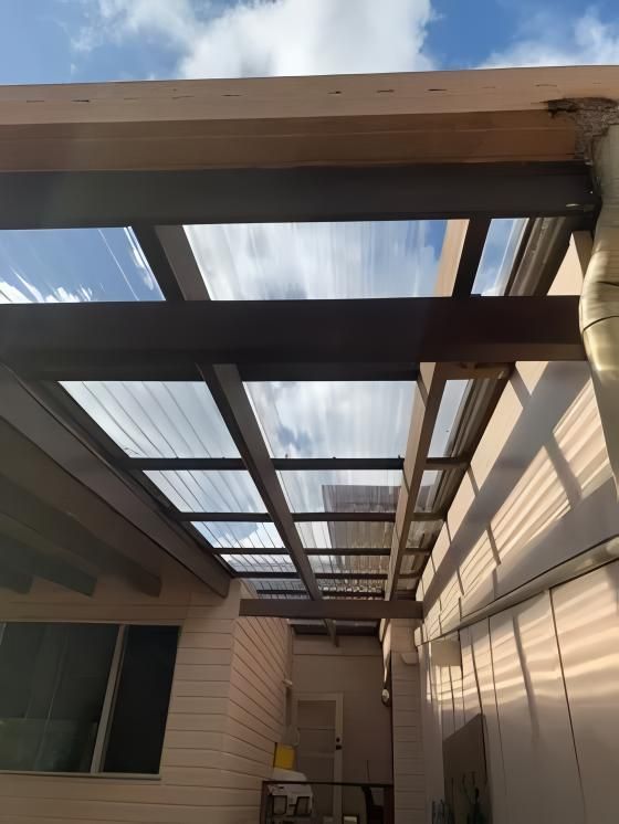 Patio Roof With Transparent Panels and Wood Beams, Casting Shadows — Blue Sky Roofing NSW In Brunswick Heads, NSW