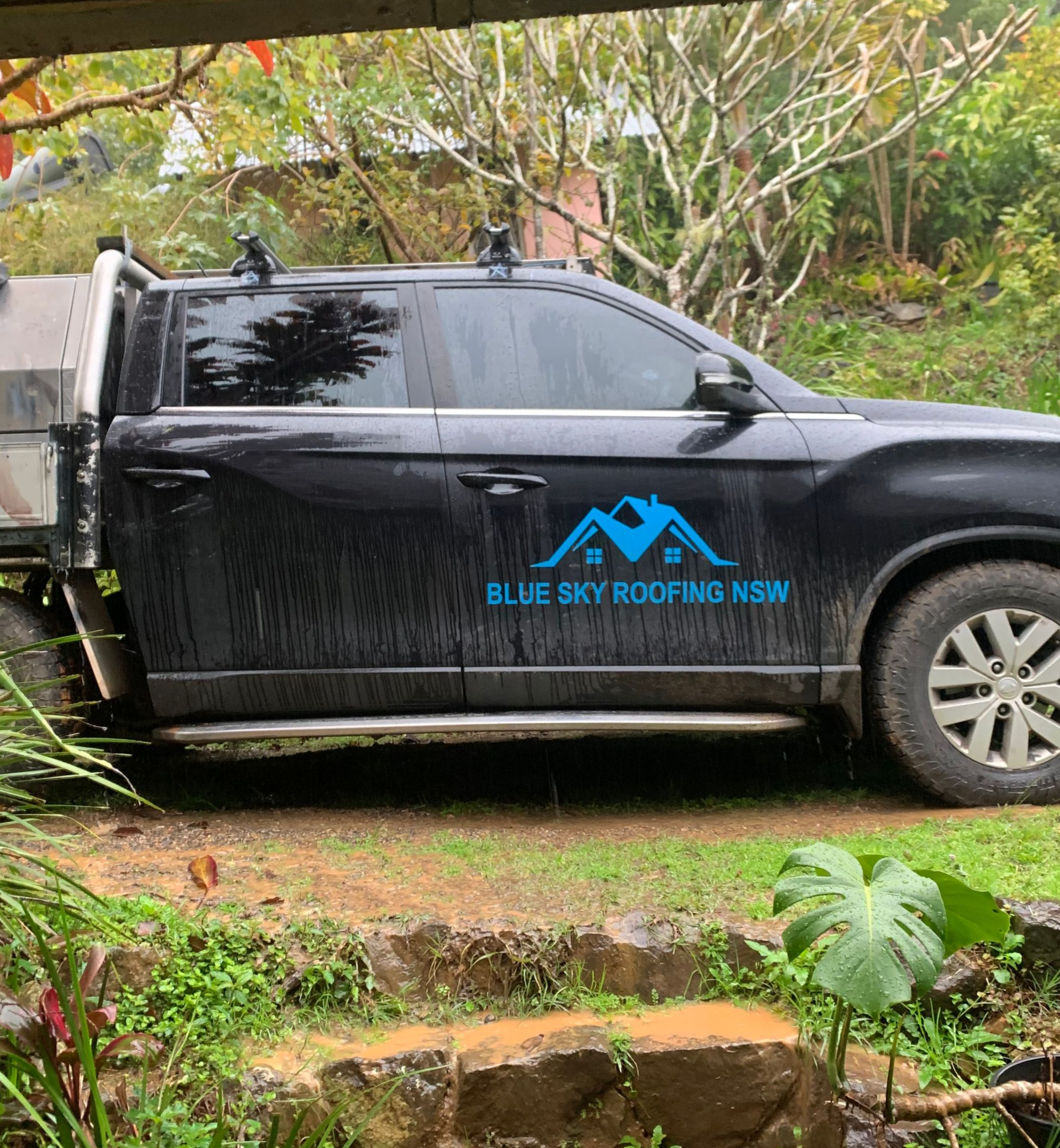 A blue sky roofing ute is parked out on patch of grass — Blue Sky Roofing NSW In Mullumbimby, NSW