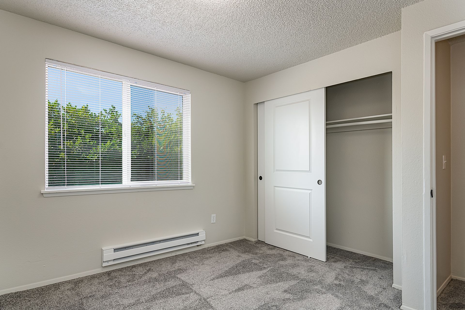 Photo showing a bedroom with a closet with dual sliding doors