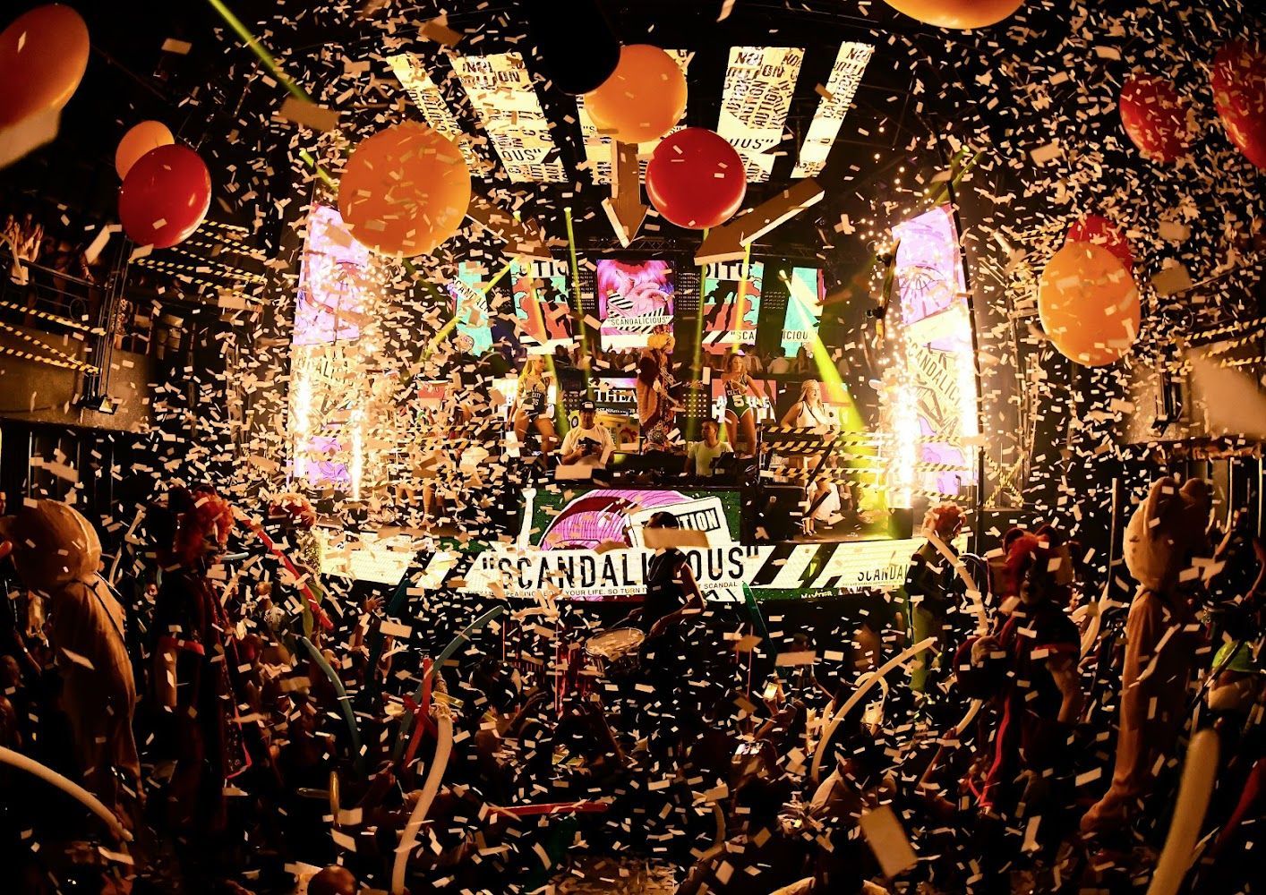 A restaurant with tables and chairs in a dark room.