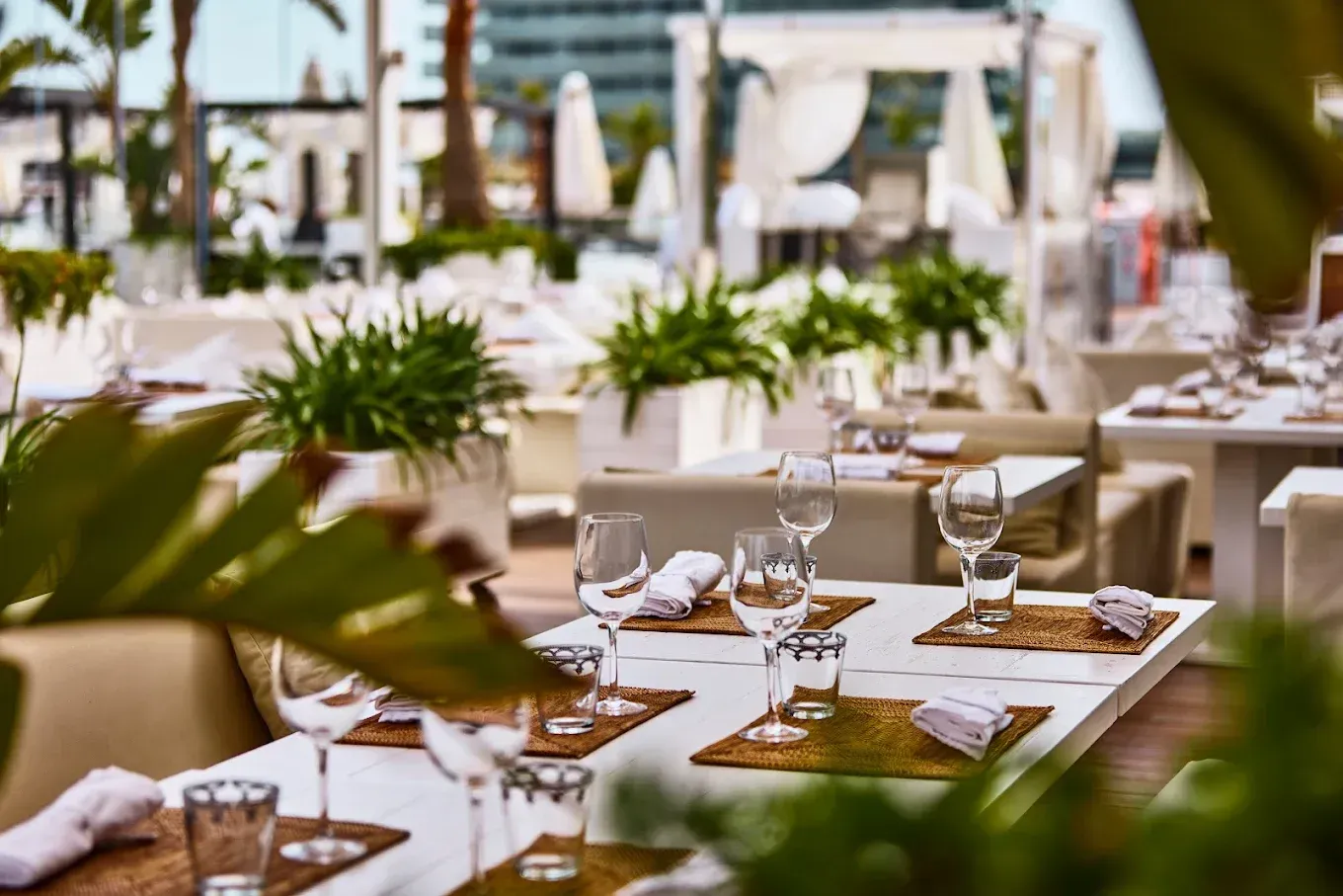 An aerial view of a beach resort with a large swimming pool