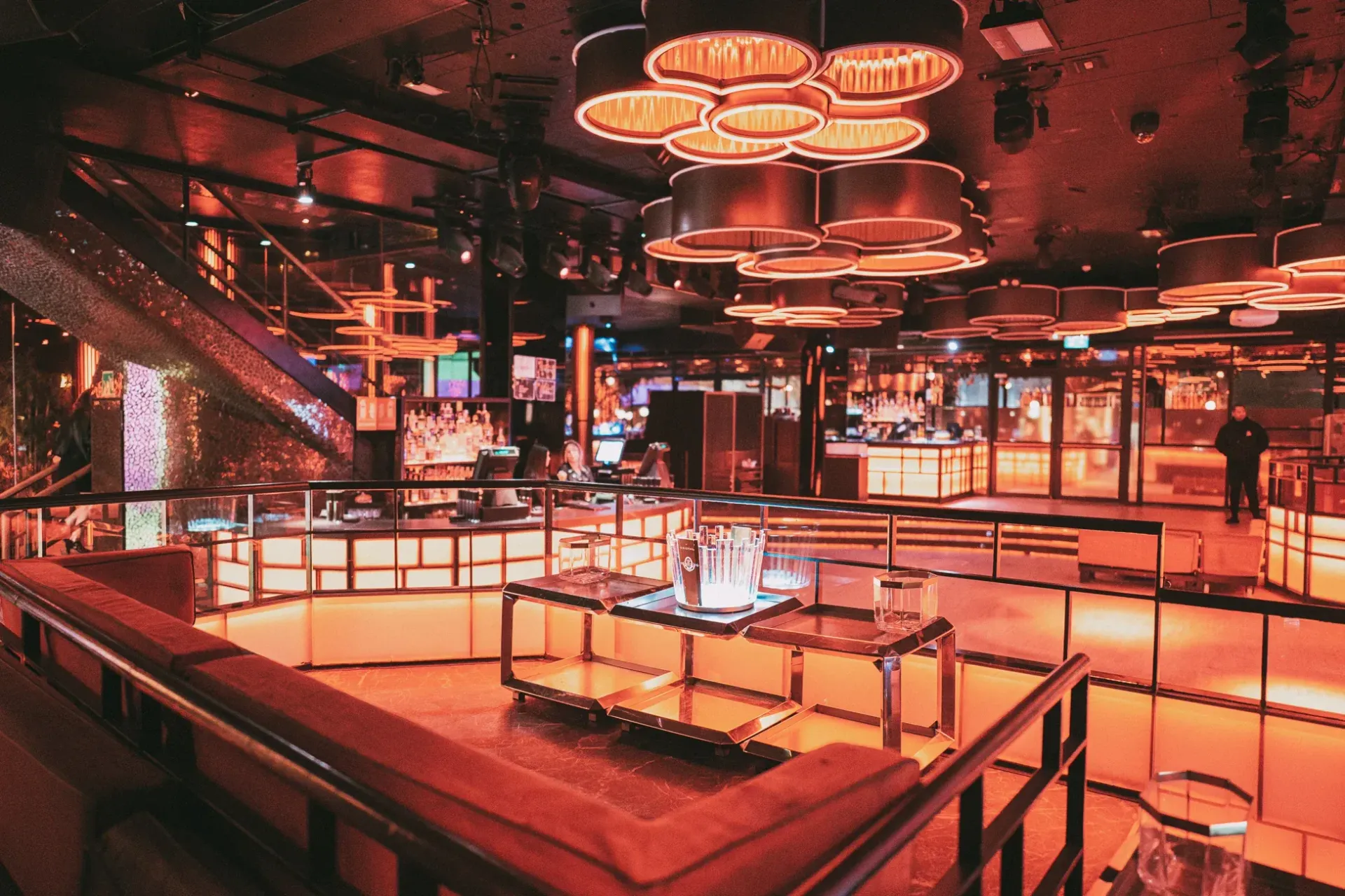 A group of people are sitting at tables in a restaurant.