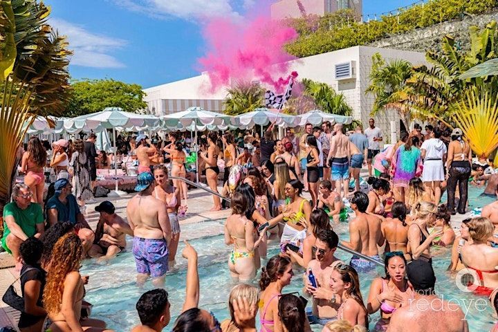 A large group of people are gathered around a swimming pool.