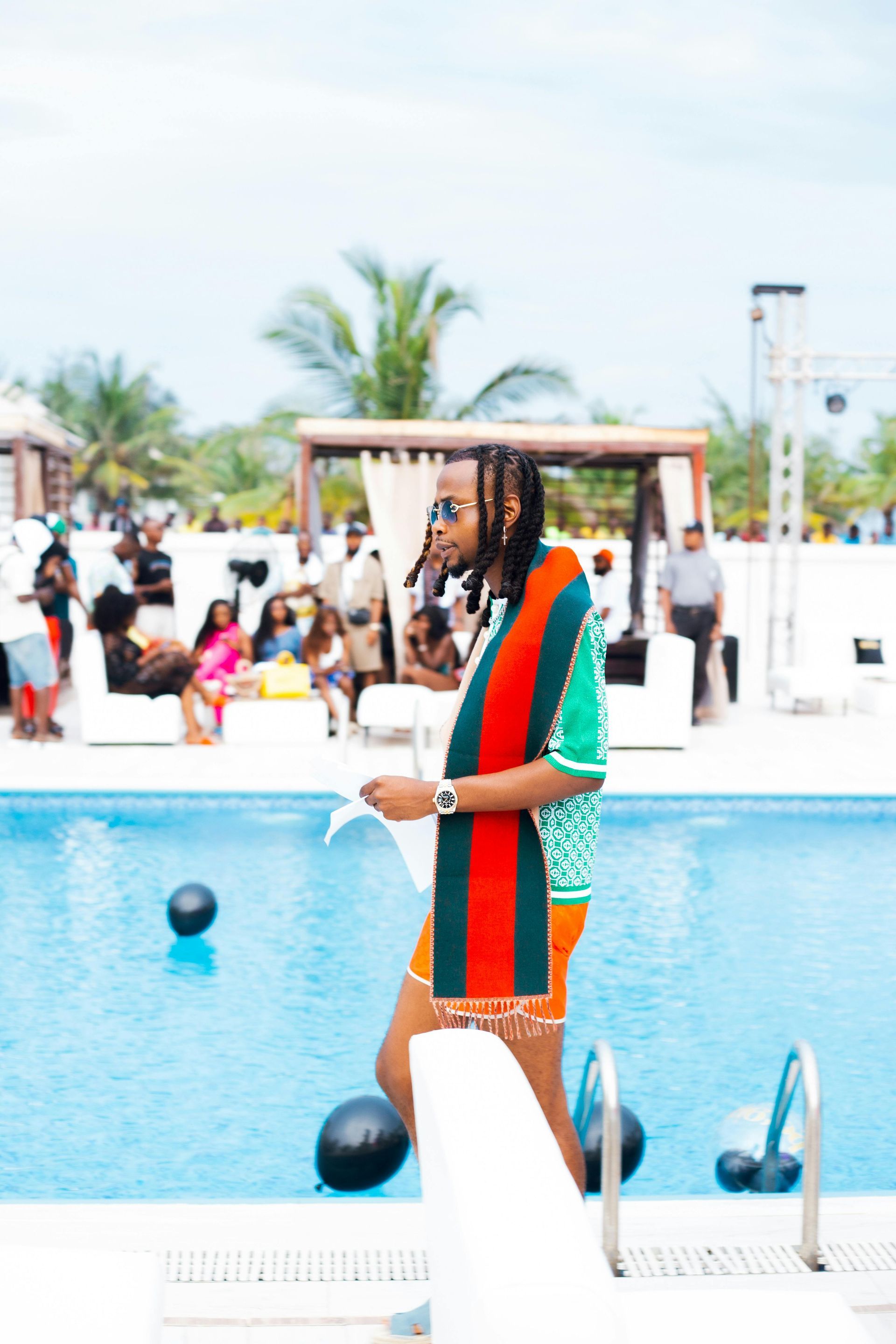 There are a lot of chairs and tables on the beach.