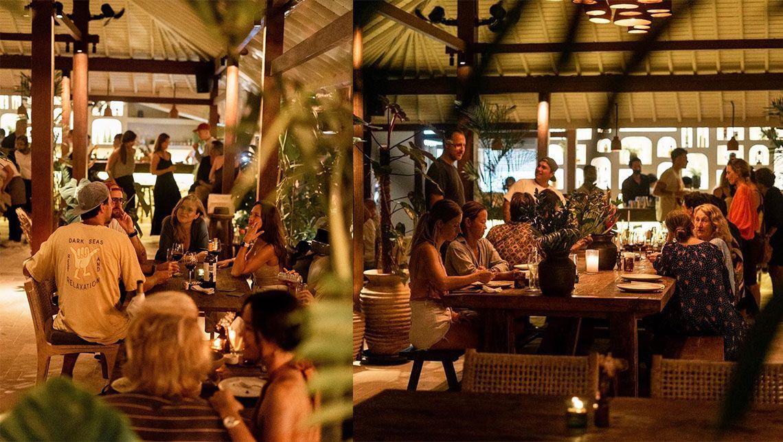 A group of people are sitting at tables in a restaurant.