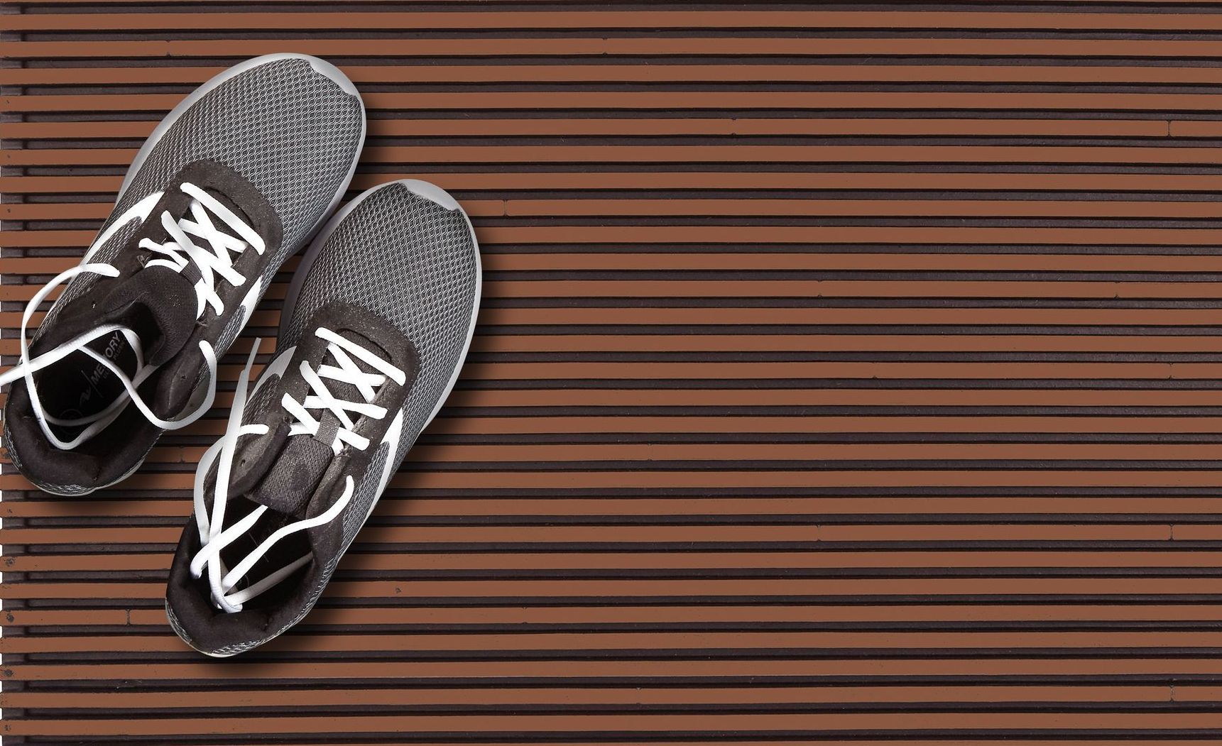 A pair of shoes are sitting on a wooden surface.